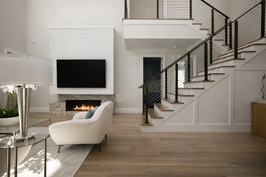 Living room with fireplace and open staircase