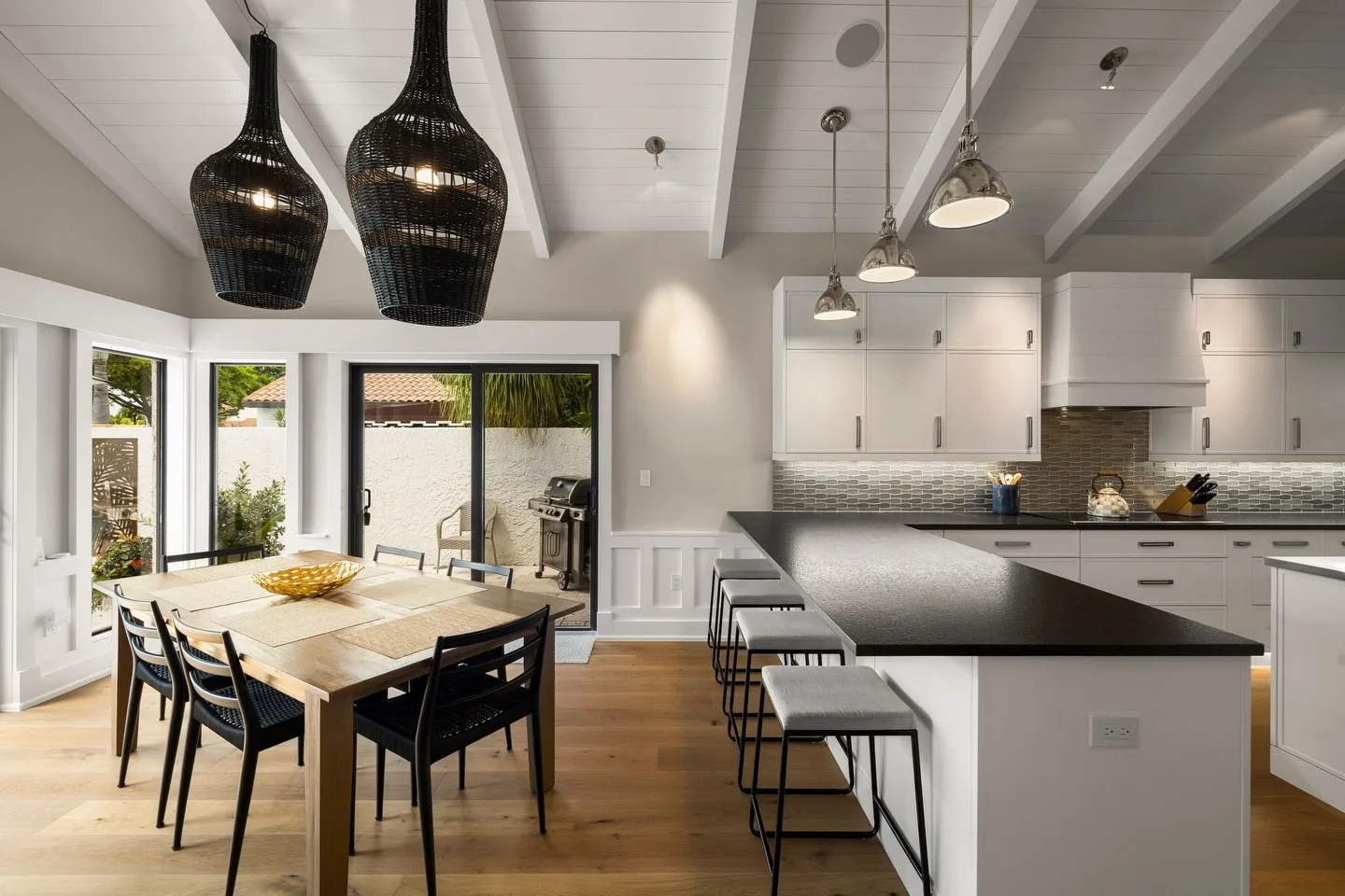 Dining room with black pendant lights and pool view