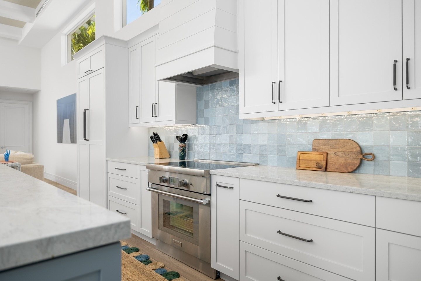 White shaker cabinets, shiplap hood and blue zellige backsplash