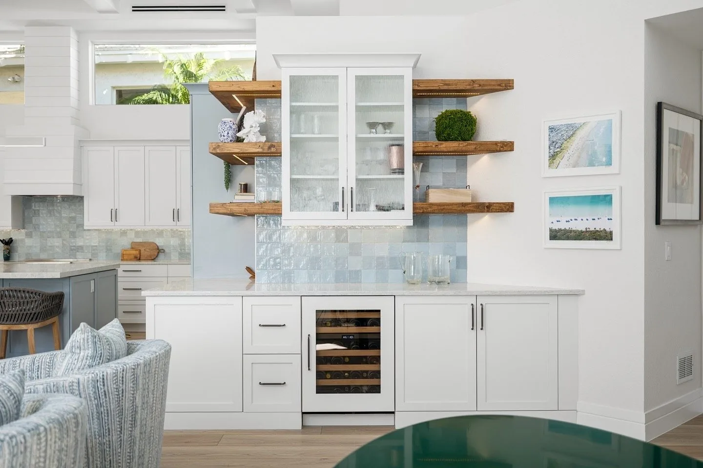 Coastal kitchen with blue cabinets and open wood shelves