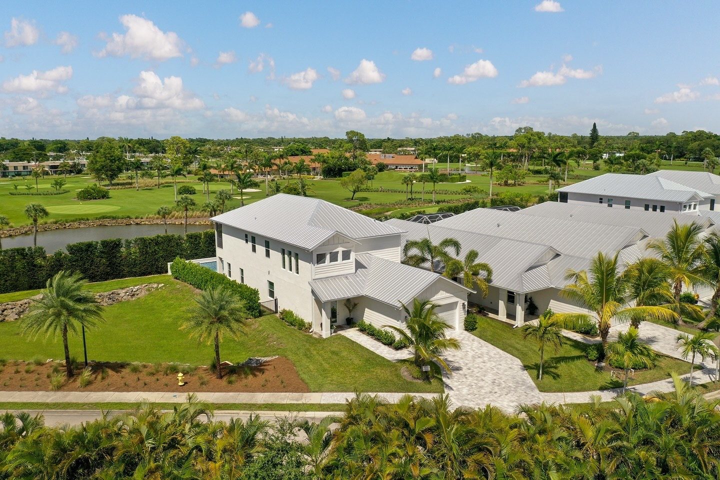 Drone photo of a finished two-story coastal home on a golf course lot
