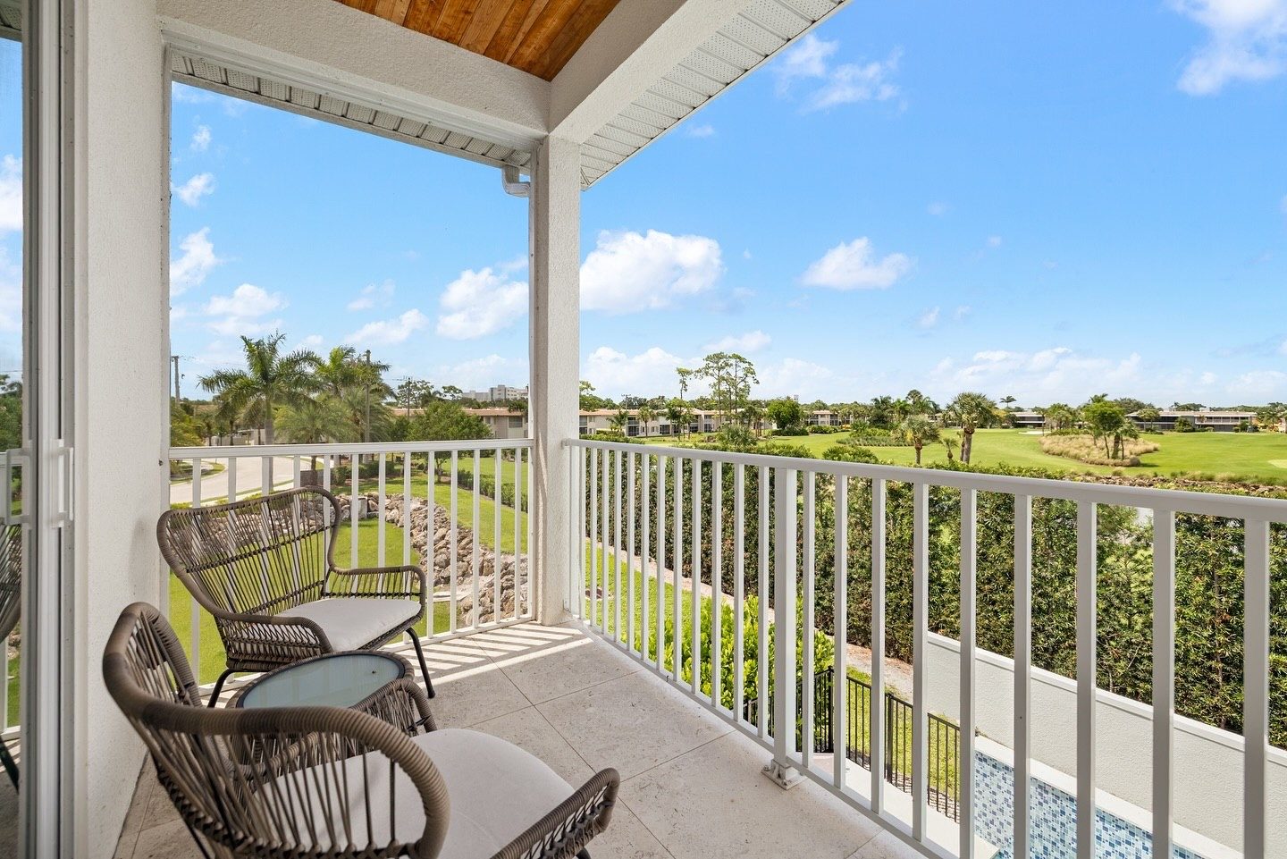 Covered balcony with chairs overlooking the golf course