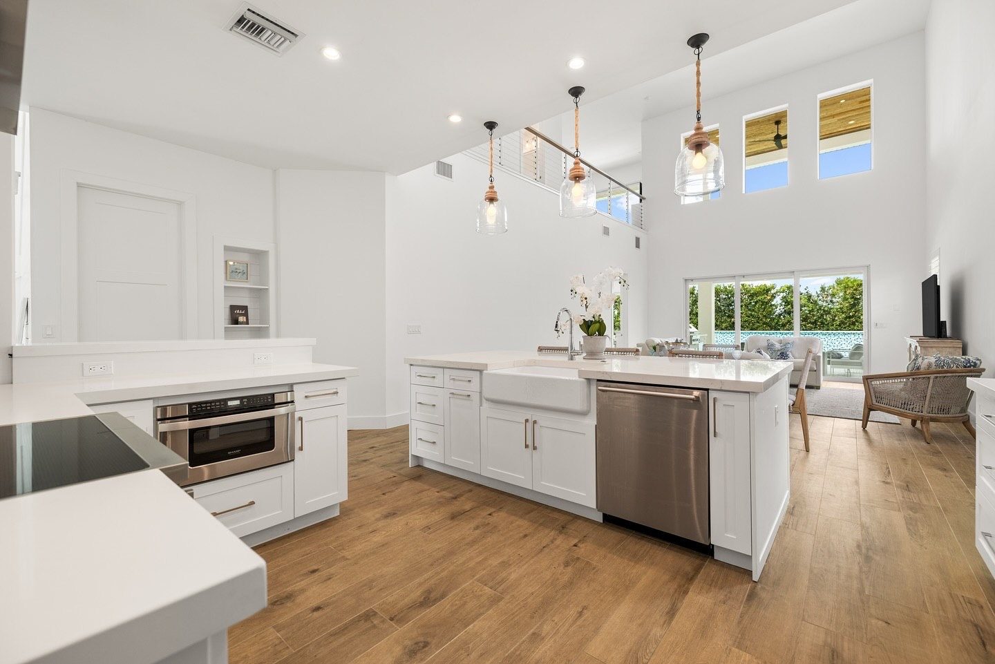 Kitchen island with farmhouse sink opening to the living room