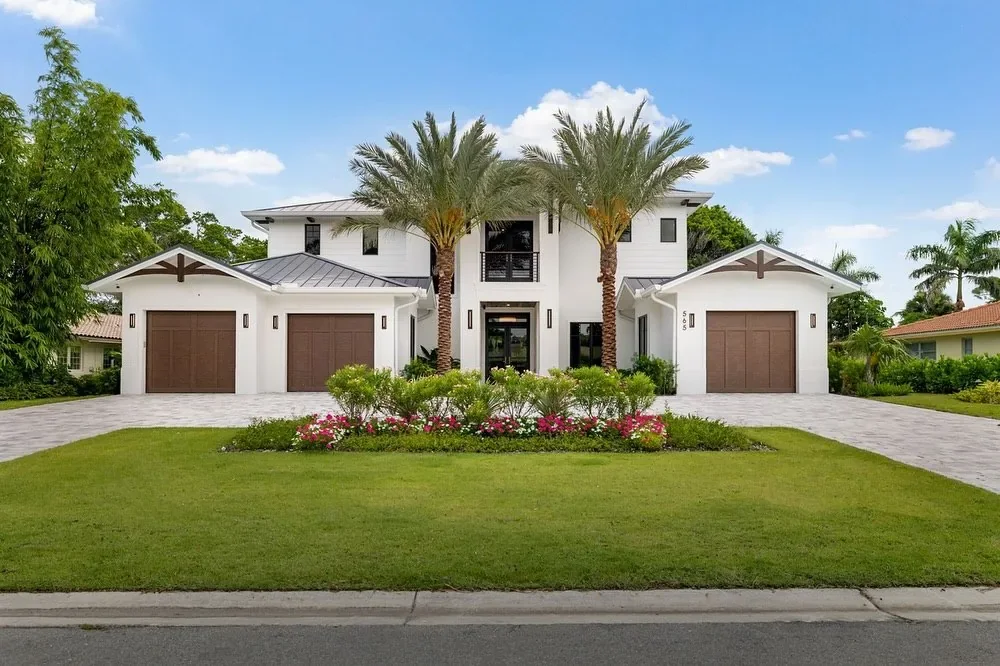Two-story home with palm trees