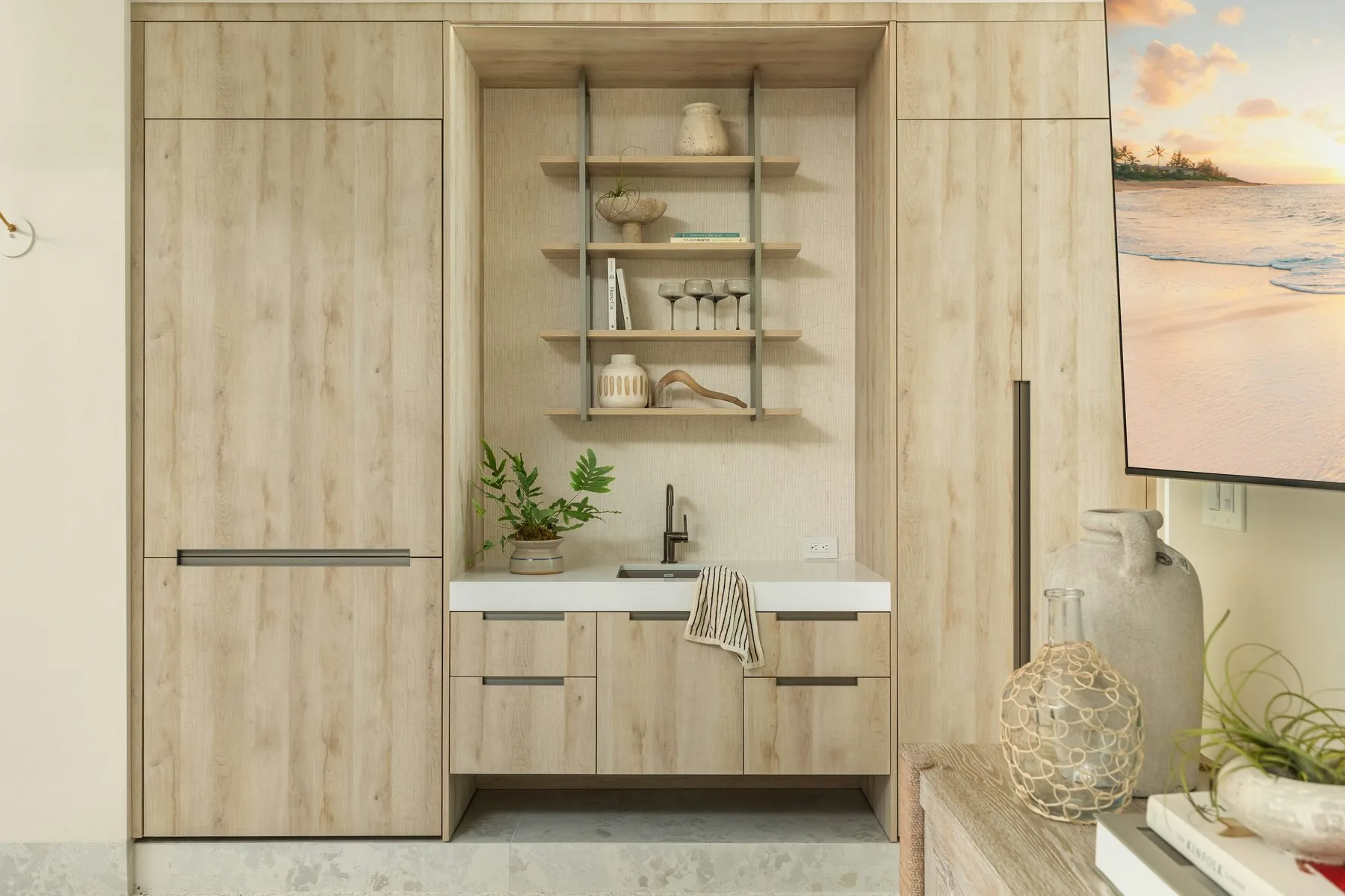 Oak wet bar and media wall with coastal art