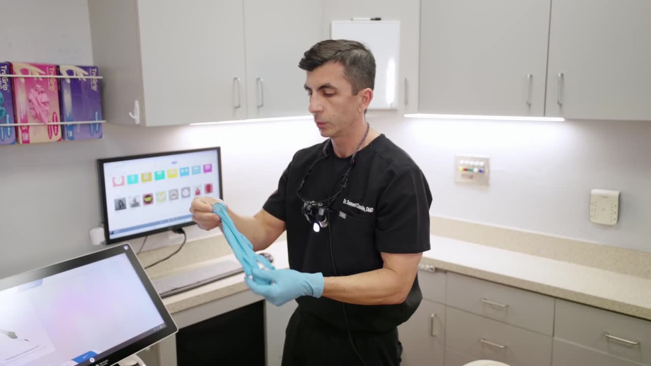 Dentist and team member talking in the office hallway