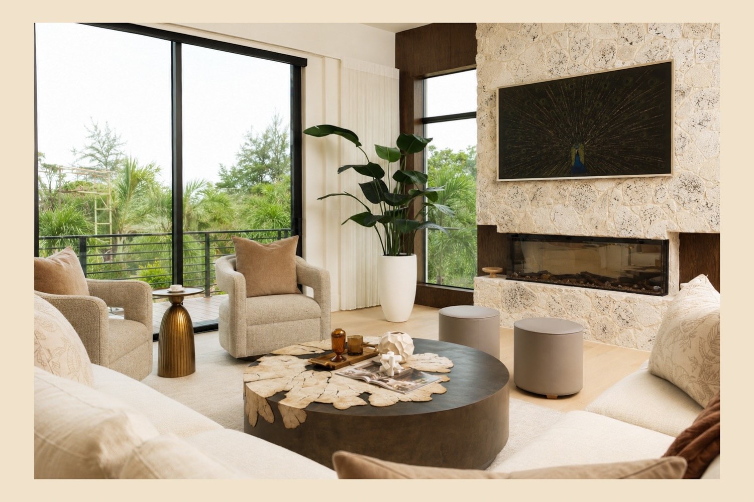 Sunlit lounge with stone fireplace and full-height windows