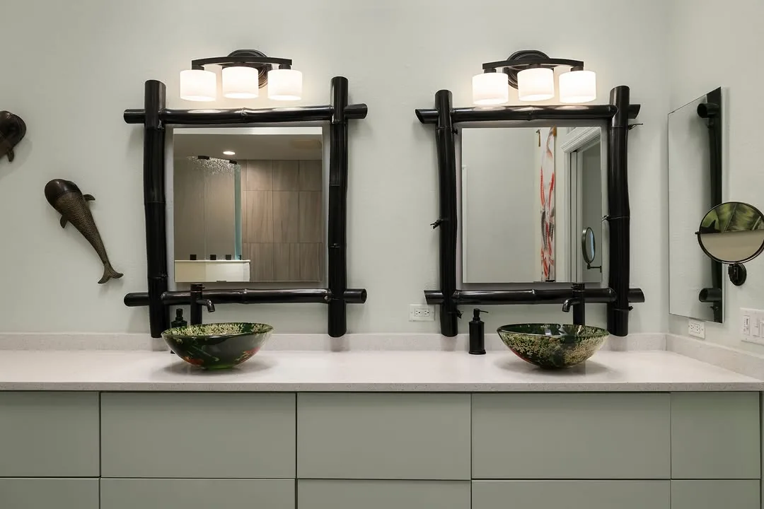 Double vanity with sculptural mirrors and vessel sinks